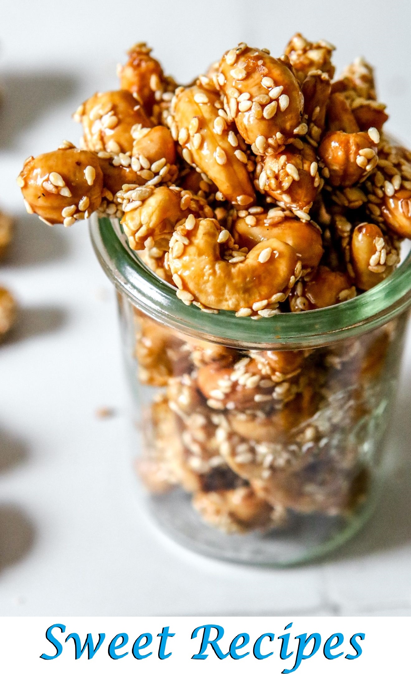 Sesame and honey cashews served in a cup, shiny and golden.